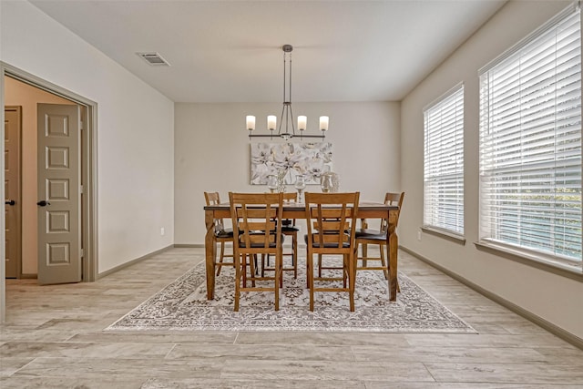 dining area featuring a chandelier and light hardwood / wood-style flooring