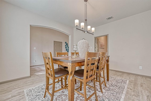 dining space featuring a chandelier and light hardwood / wood-style floors