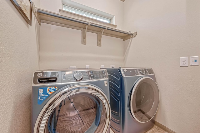 laundry area with washing machine and clothes dryer