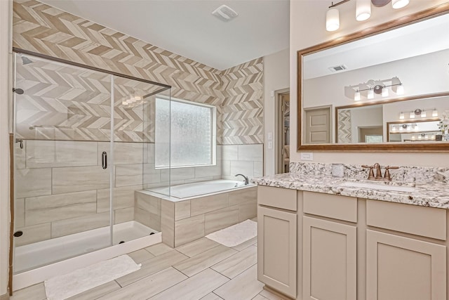 bathroom featuring vanity and shower with separate bathtub