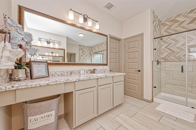 bathroom featuring walk in shower and vanity