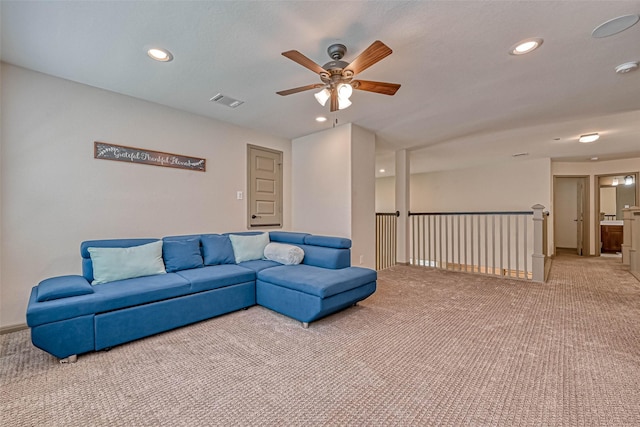 carpeted living room featuring ceiling fan