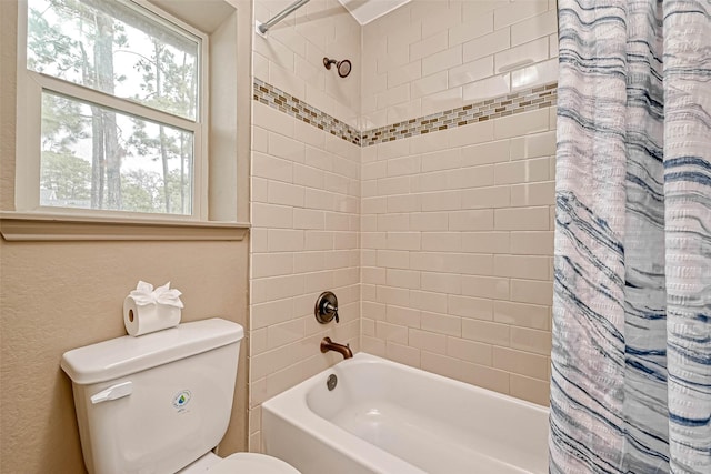 bathroom featuring toilet and shower / bathtub combination with curtain