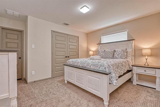 bedroom featuring a closet and light carpet