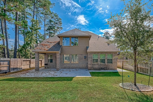 rear view of property featuring a patio area and a lawn