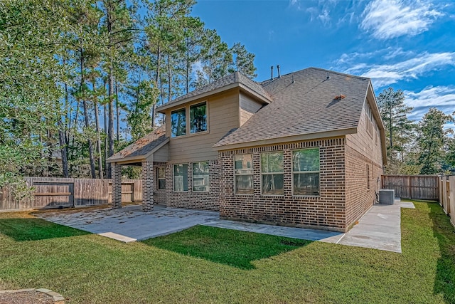 back of property featuring a lawn, cooling unit, and a patio