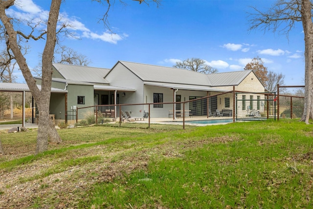 rear view of property with a patio area and a lawn