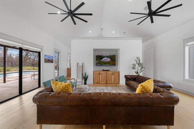 living room with ceiling fan and light hardwood / wood-style flooring