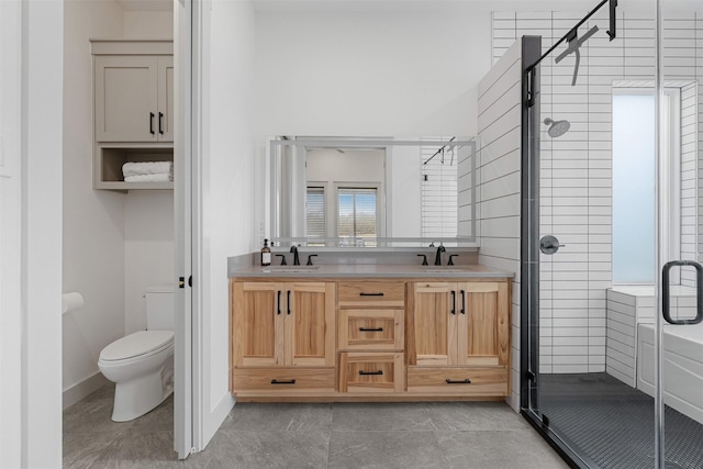 bathroom featuring toilet, vanity, tile patterned flooring, and a shower with door