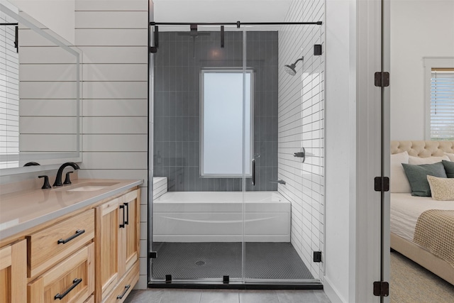 bathroom featuring tile patterned flooring, vanity, and shower with separate bathtub