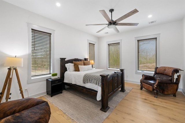 bedroom with ceiling fan and light hardwood / wood-style floors