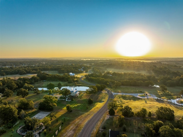 aerial view at dusk with a water view