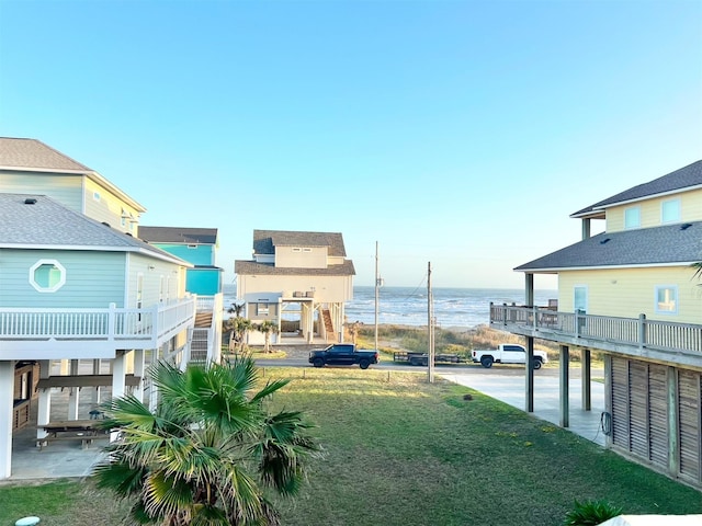 view of yard with a water view and a balcony