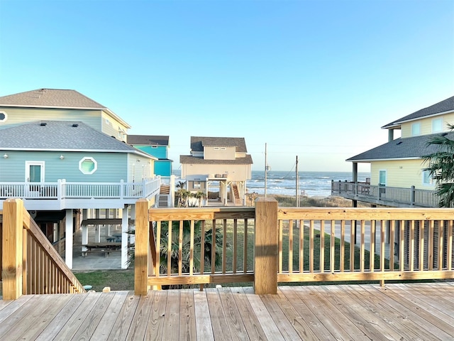 wooden terrace featuring a water view