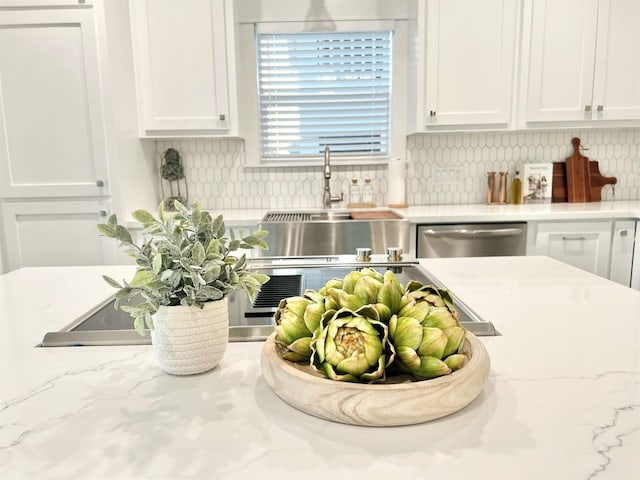 room details featuring tasteful backsplash, white cabinets, dishwasher, and light stone counters