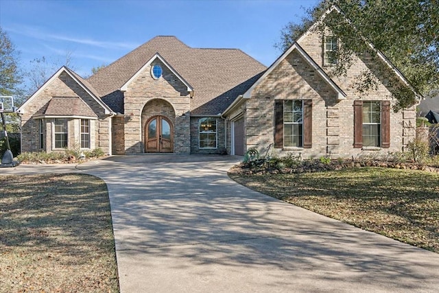 view of front of house with a front lawn and french doors