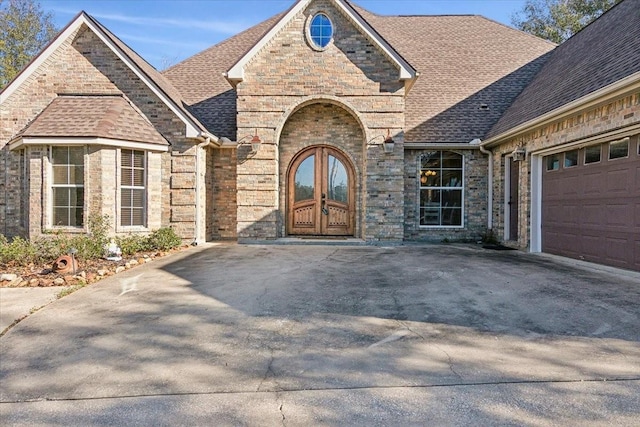 property entrance with a garage and french doors