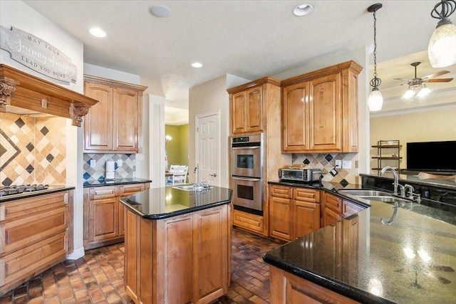 kitchen featuring backsplash, appliances with stainless steel finishes, sink, and pendant lighting