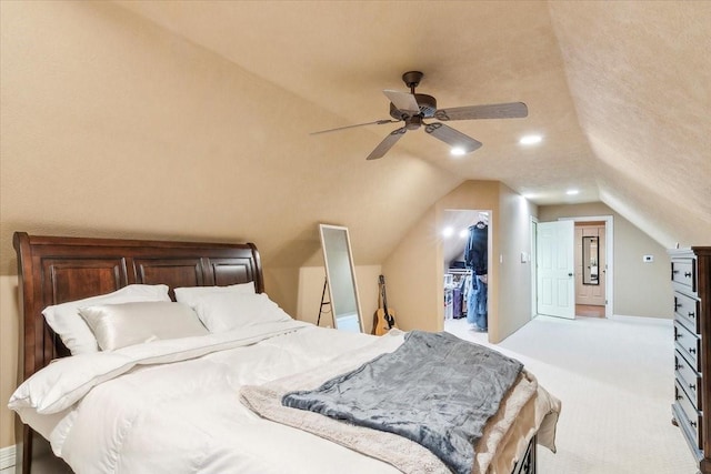 carpeted bedroom with lofted ceiling, a closet, a textured ceiling, and ceiling fan