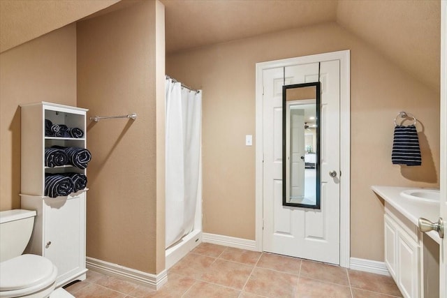 bathroom featuring toilet, vanity, vaulted ceiling, tile patterned floors, and curtained shower