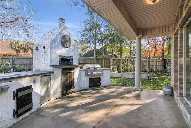 view of patio / terrace with a grill, area for grilling, and sink