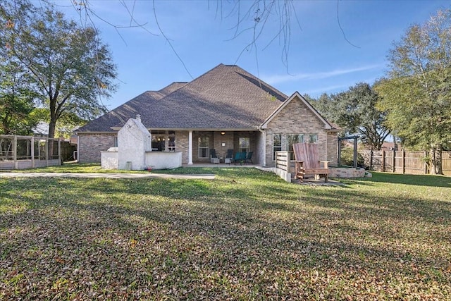 rear view of property with a patio area and a yard