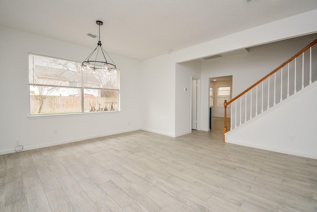 interior space featuring light hardwood / wood-style flooring and an inviting chandelier