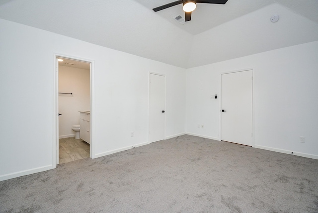 unfurnished bedroom with light carpet, ceiling fan, and ensuite bathroom