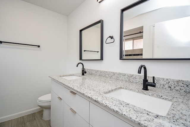 bathroom with hardwood / wood-style flooring, toilet, and vanity