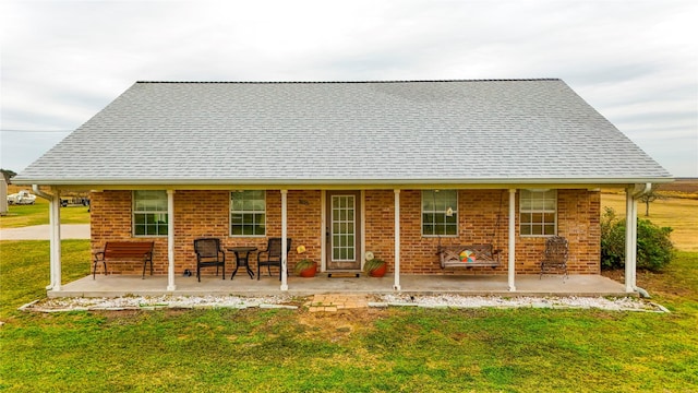 back of house featuring a patio area and a yard