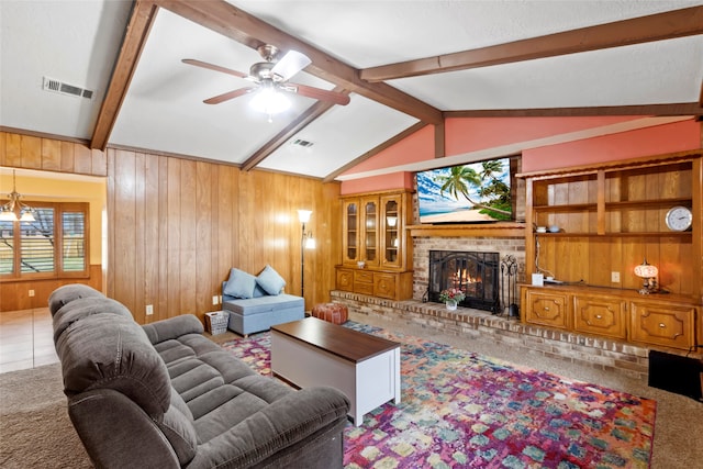 carpeted living room featuring a brick fireplace, ceiling fan, wooden walls, and lofted ceiling with beams