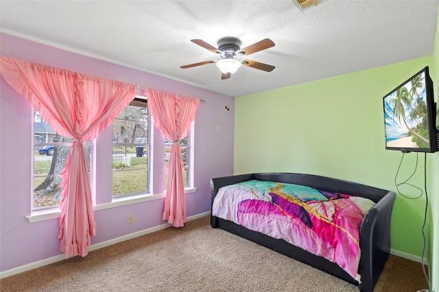 bedroom featuring ceiling fan and carpet