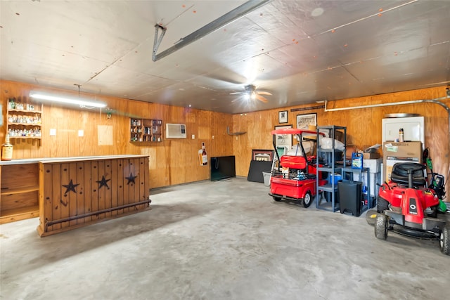 garage with an AC wall unit and wooden walls