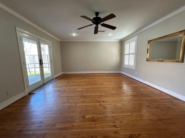 unfurnished room featuring ceiling fan, hardwood / wood-style floors, ornamental molding, and french doors
