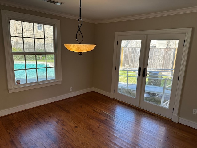 unfurnished dining area with wood-type flooring, plenty of natural light, and crown molding