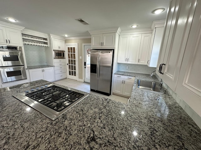 kitchen featuring sink, white cabinets, and stainless steel appliances