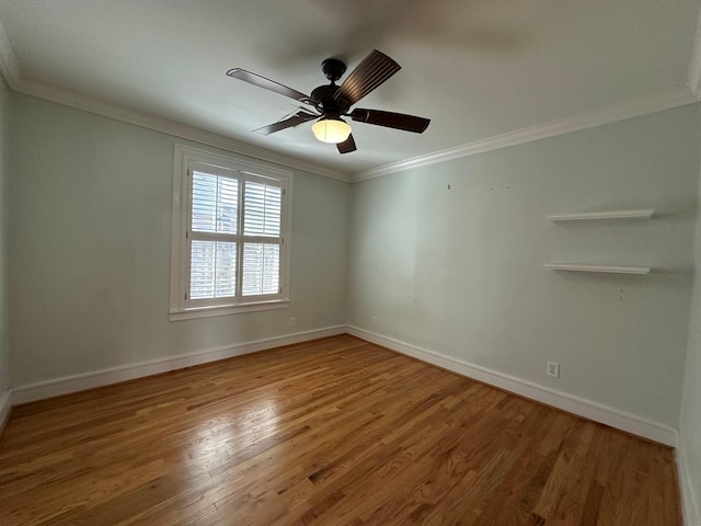 empty room featuring ceiling fan, wood-type flooring, and ornamental molding