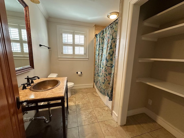 bathroom featuring toilet, ornamental molding, tile patterned flooring, and vanity
