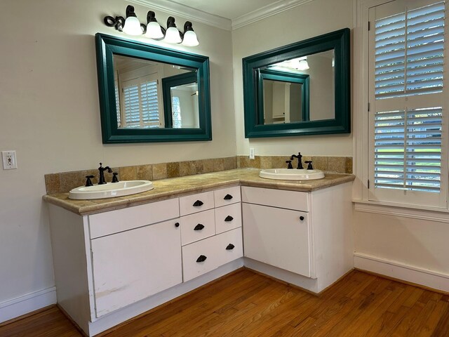 bathroom with hardwood / wood-style flooring, vanity, and ornamental molding