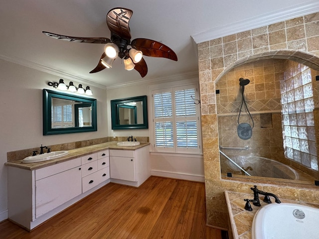 bathroom featuring a bathing tub, vanity, ceiling fan, hardwood / wood-style flooring, and crown molding