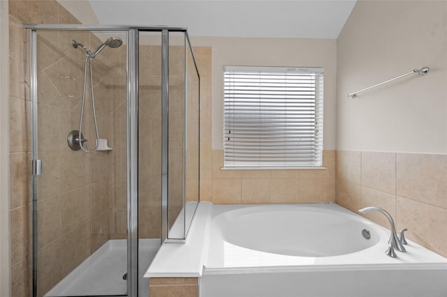 bathroom featuring shower with separate bathtub and lofted ceiling