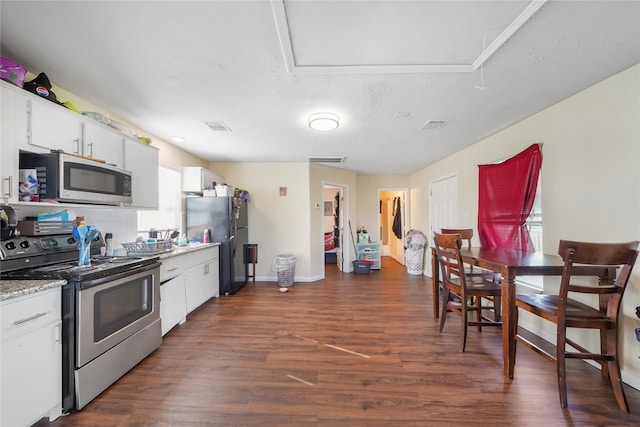 kitchen with white cabinetry, dark hardwood / wood-style floors, stainless steel appliances, and a textured ceiling