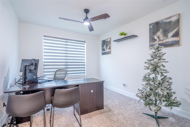 carpeted home office featuring ceiling fan