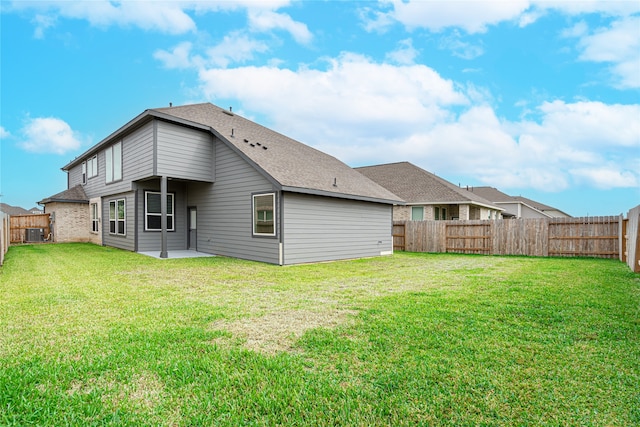 back of house featuring a lawn and a patio