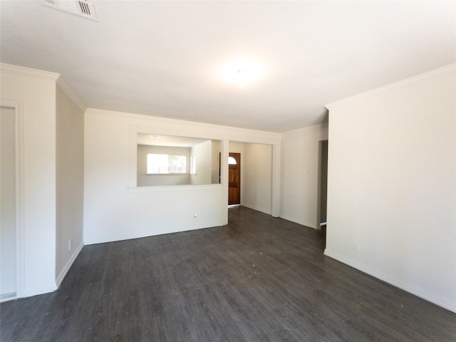 spare room featuring dark hardwood / wood-style flooring and ornamental molding