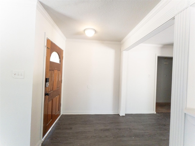 hallway with dark wood-type flooring, a textured ceiling, and ornamental molding