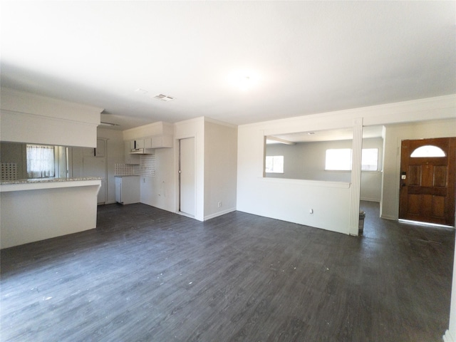 unfurnished living room featuring dark hardwood / wood-style floors