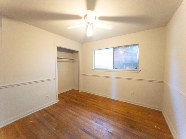 unfurnished bedroom featuring ceiling fan, dark hardwood / wood-style flooring, and a closet