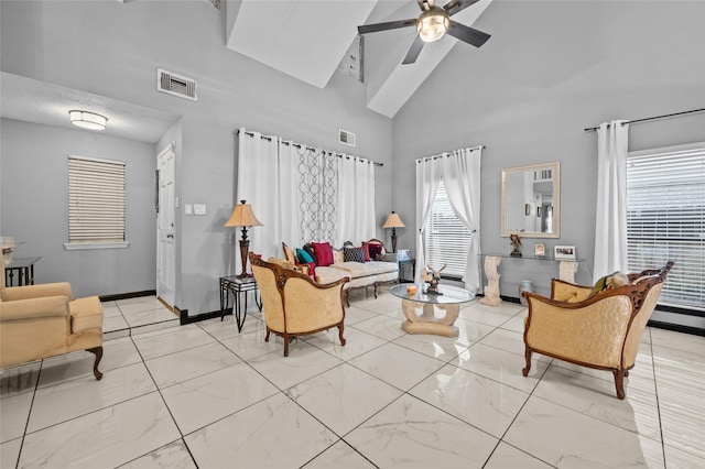 living room with high vaulted ceiling and ceiling fan