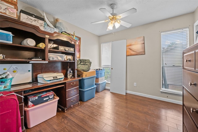 office area with ceiling fan, a healthy amount of sunlight, and dark hardwood / wood-style floors